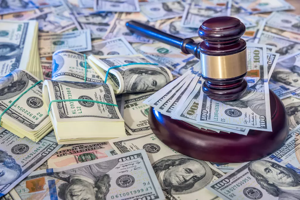 Auction concept - judges gavel against us dollar background.