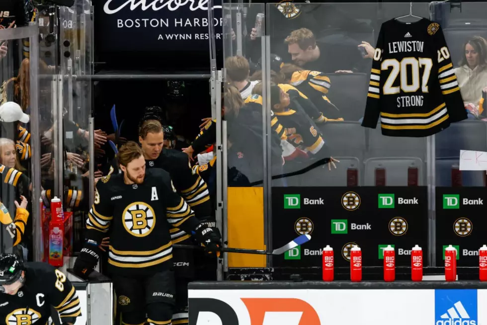 A hockey jersey hangs behind the Boston Bruins bench as a tribute to the victims of the mass shooting in Lewiston, Maine